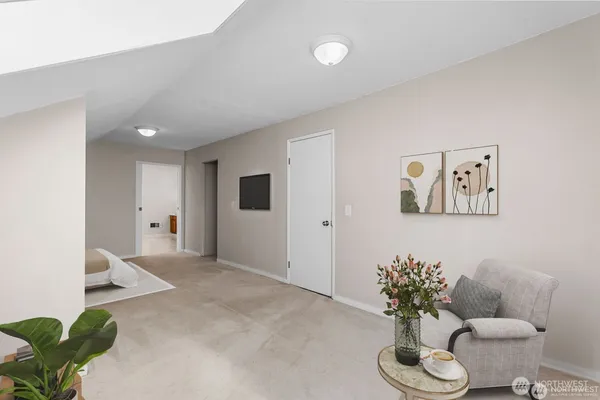 a living room with furniture and flowers