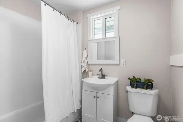 a bathroom with a toilet a sink and a bathtub