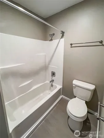 a bathroom with a toilet and a bathtub