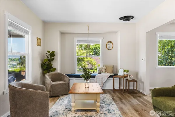 a living room with furniture a window and a chandelier