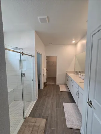 a bathroom with a double vanity sink and mirror