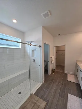 a bathroom with a shower and a glass door