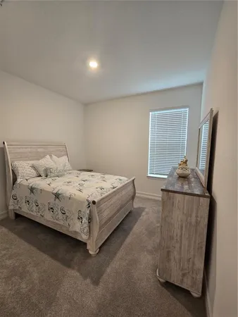 a bedroom with a bed and a television