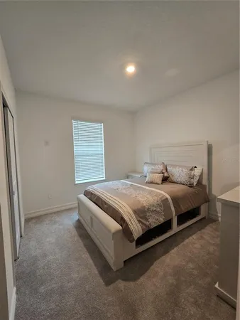 a bedroom with a bed and window