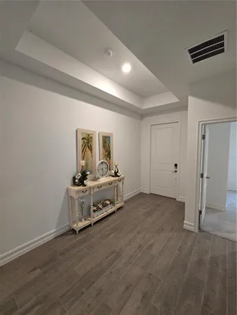 a view of a room with wooden floor and fan