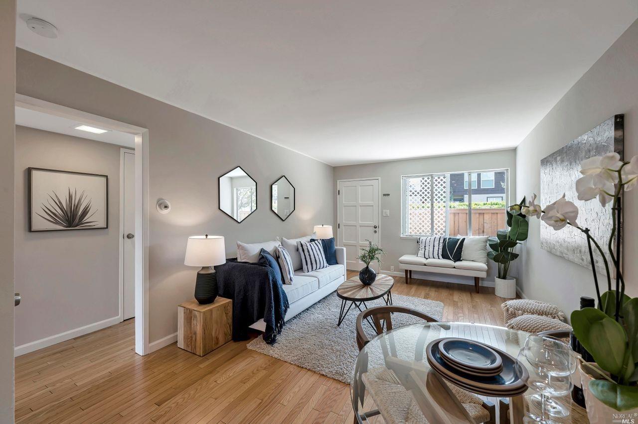 a living room with furniture and a wooden floor