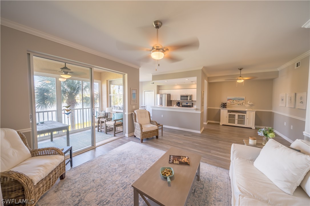 14101 Brant Point Circle, Unit 3203 Fort Myers, FL 33919 - Photo 11 of 34 a living room with furniture and a large window