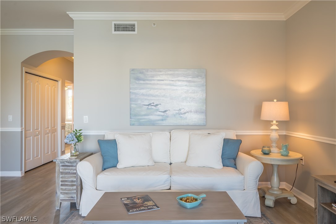 14101 Brant Point Circle, Unit 3203 Fort Myers, FL 33919 - Photo 16 of 34 a living room with a couch and wooden floor