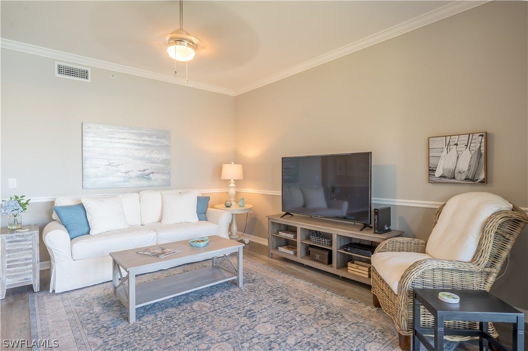 14101 Brant Point Circle, Unit 3203 Fort Myers, FL 33919 - Photo 17 of 34 a living room with furniture and a flat screen tv