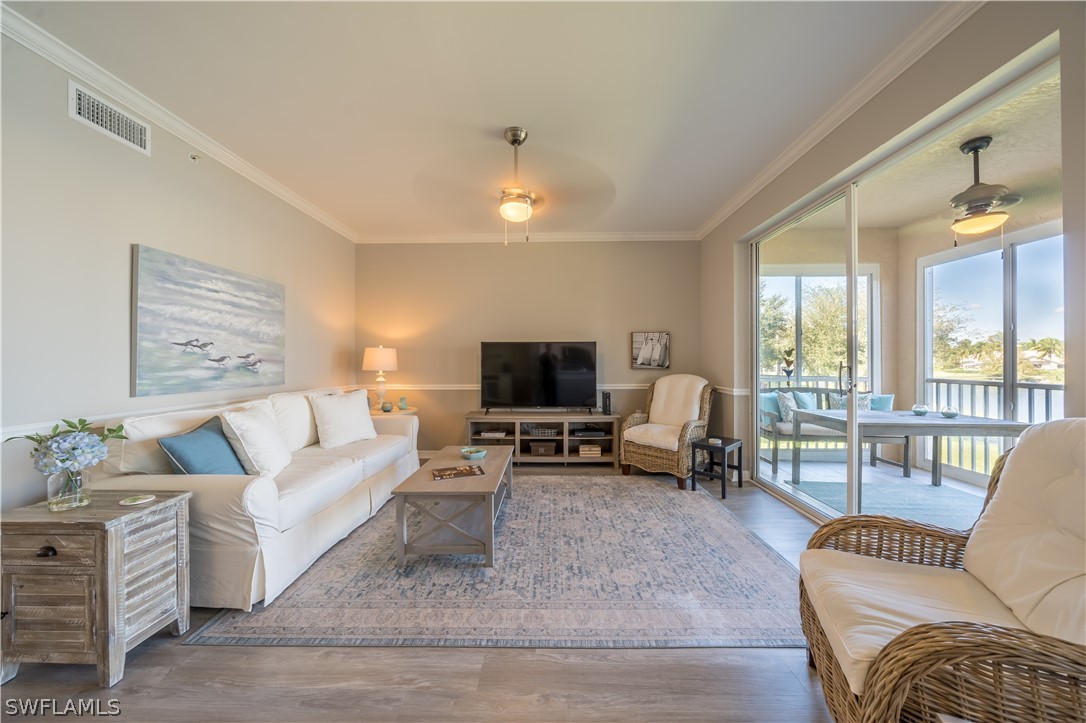 14101 Brant Point Circle, Unit 3203 Fort Myers, FL 33919 - Photo 18 of 34 a living room with furniture and a flat screen tv