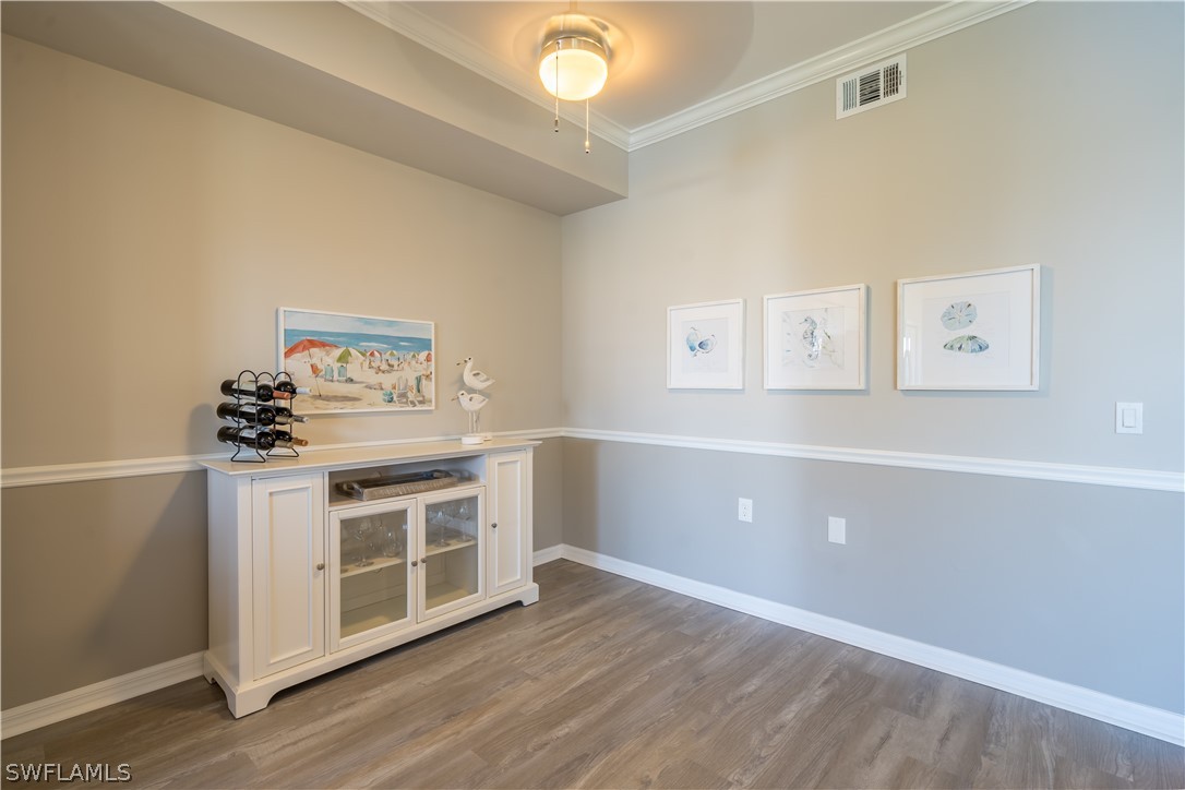 14101 Brant Point Circle, Unit 3203 Fort Myers, FL 33919 - Photo 20 of 34 a kitchen with cabinets and wooden floor