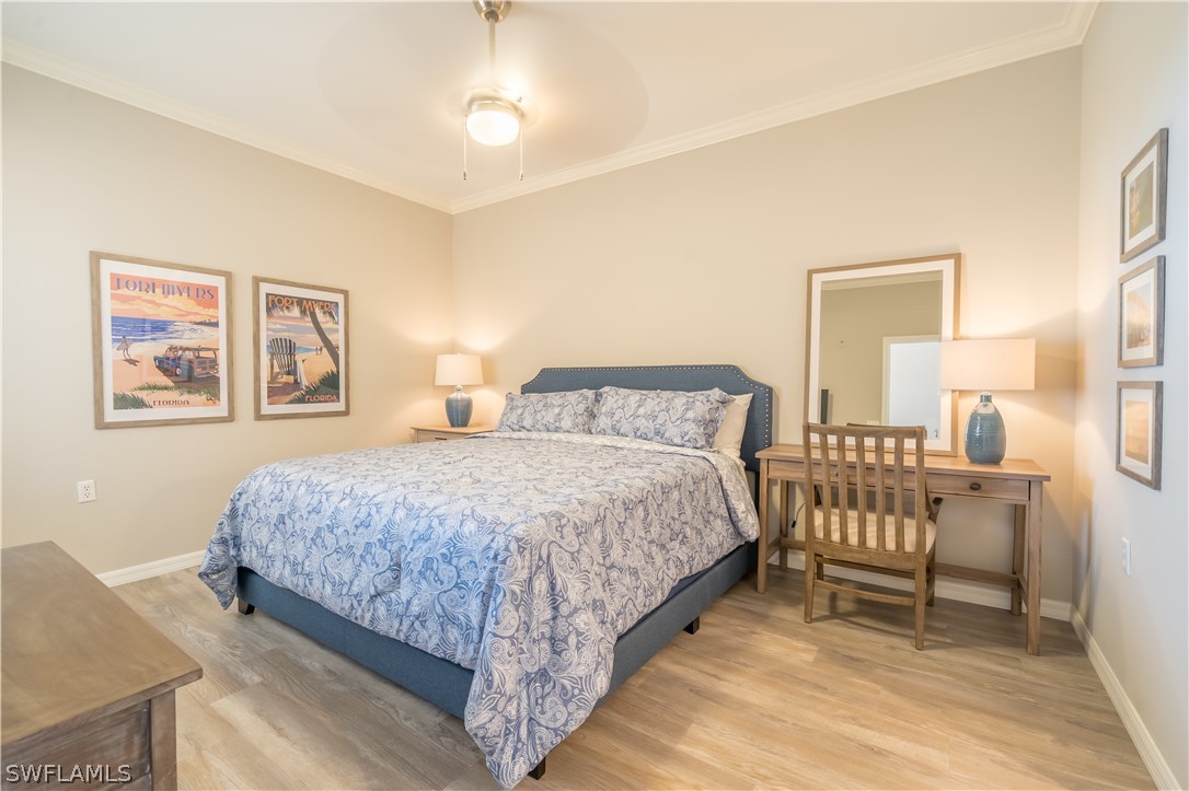 14101 Brant Point Circle, Unit 3203 Fort Myers, FL 33919 - Photo 21 of 34 a bedroom with a bed and a chair
