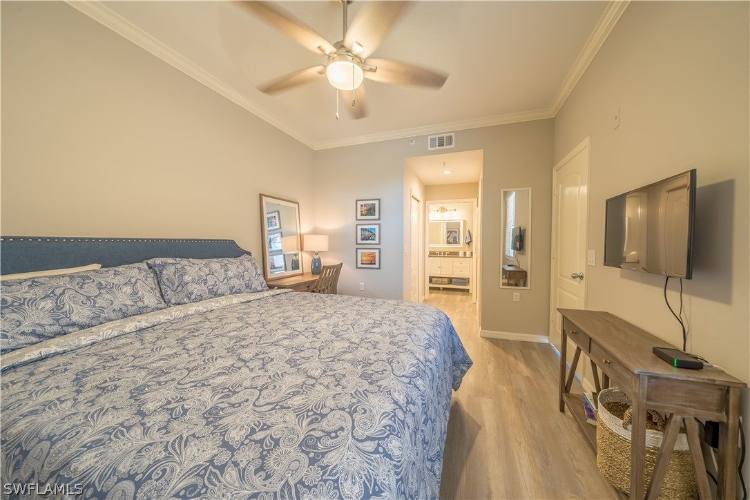 14101 Brant Point Circle, Unit 3203 Fort Myers, FL 33919 - Photo 22 of 34 a spacious bedroom with a bed and a flat screen tv
