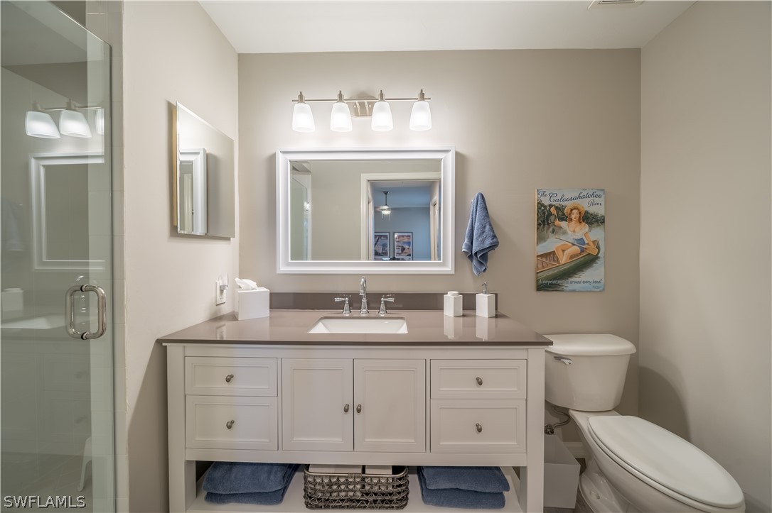 14101 Brant Point Circle, Unit 3203 Fort Myers, FL 33919 - Photo 24 of 34 a bathroom with a double vanity sink and a mirror