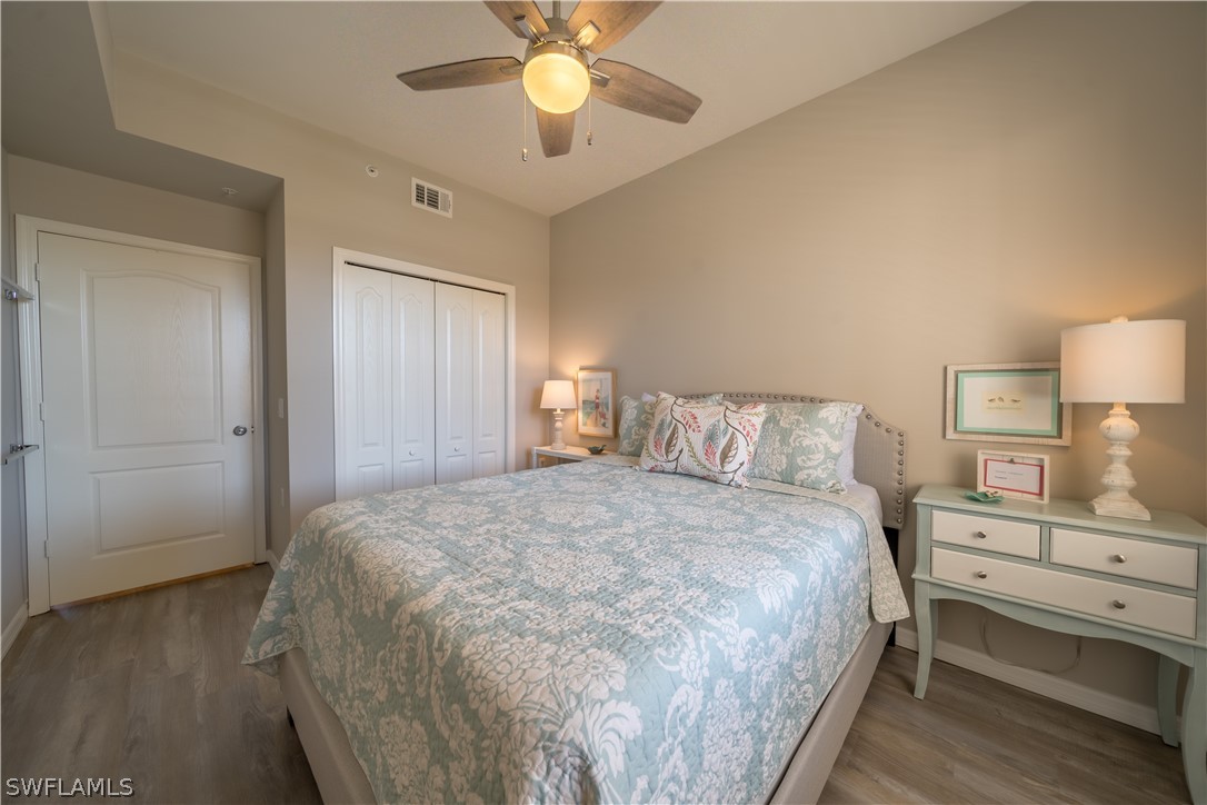 14101 Brant Point Circle, Unit 3203 Fort Myers, FL 33919 - Photo 27 of 34 a bedroom with a bed and a lamp on dresser
