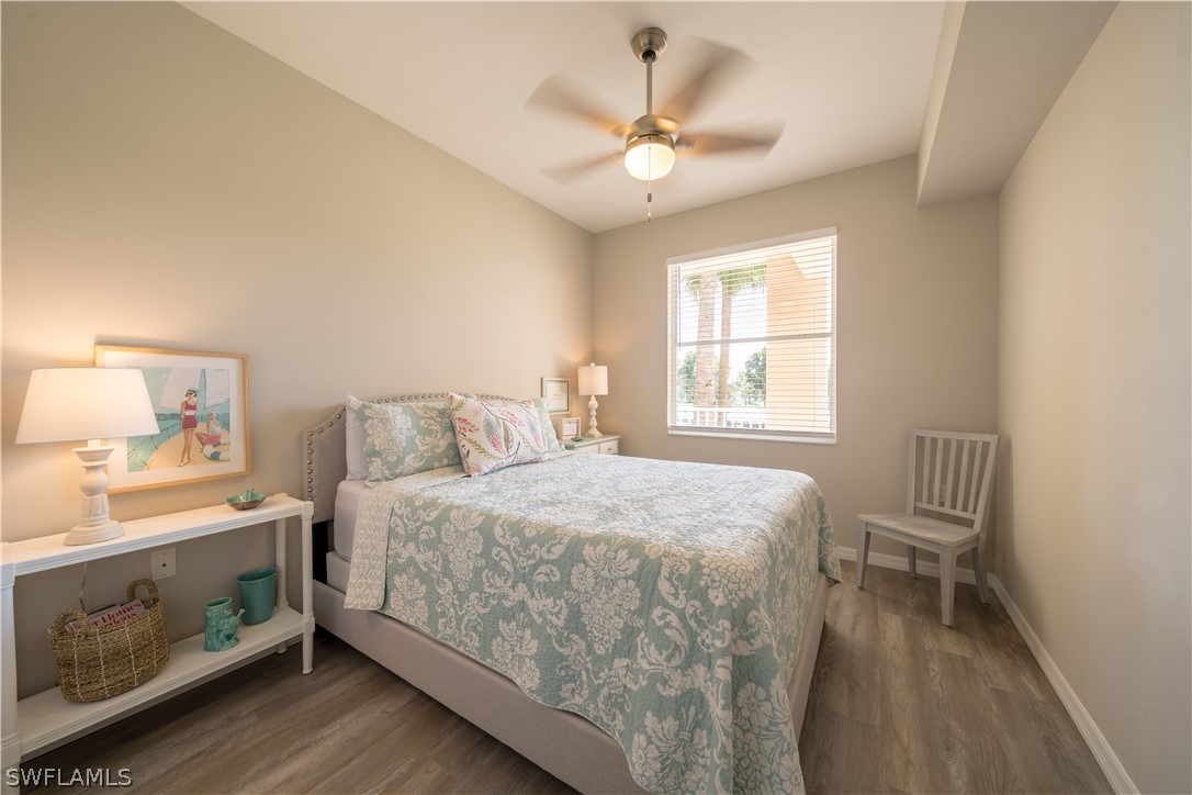 14101 Brant Point Circle, Unit 3203 Fort Myers, FL 33919 - Photo 28 of 34 a bedroom with a bed and a chandelier