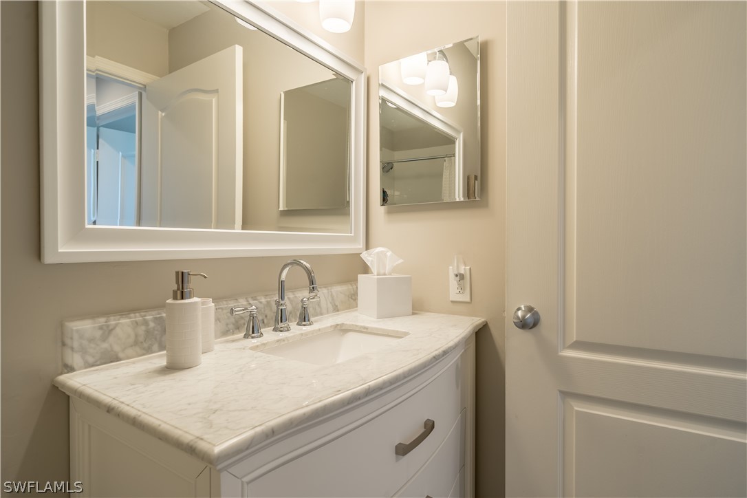 14101 Brant Point Circle, Unit 3203 Fort Myers, FL 33919 - Photo 30 of 34 a bathroom with a sink and a mirror