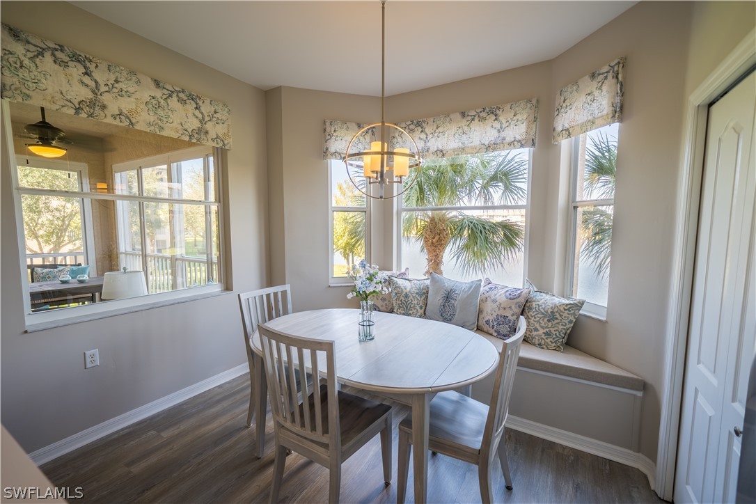 14101 Brant Point Circle, Unit 3203 Fort Myers, FL 33919 - Photo 5 of 34 a view of a dining room with furniture large windows and wooden floor