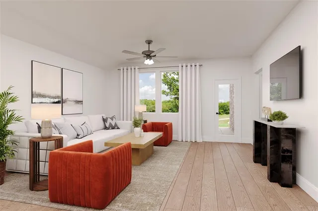 a living room with furniture and a wooden floor