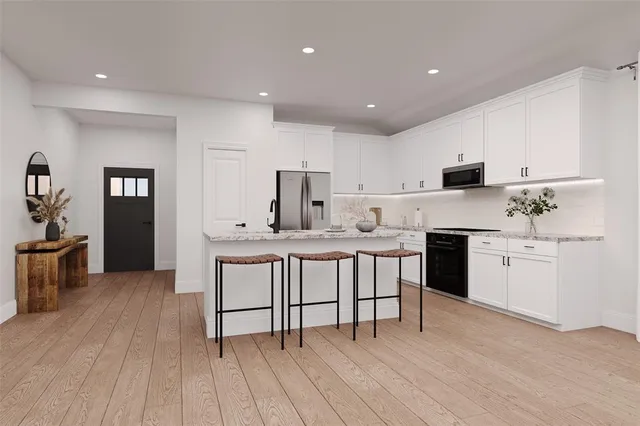 a kitchen with a sink cabinets and wooden floor