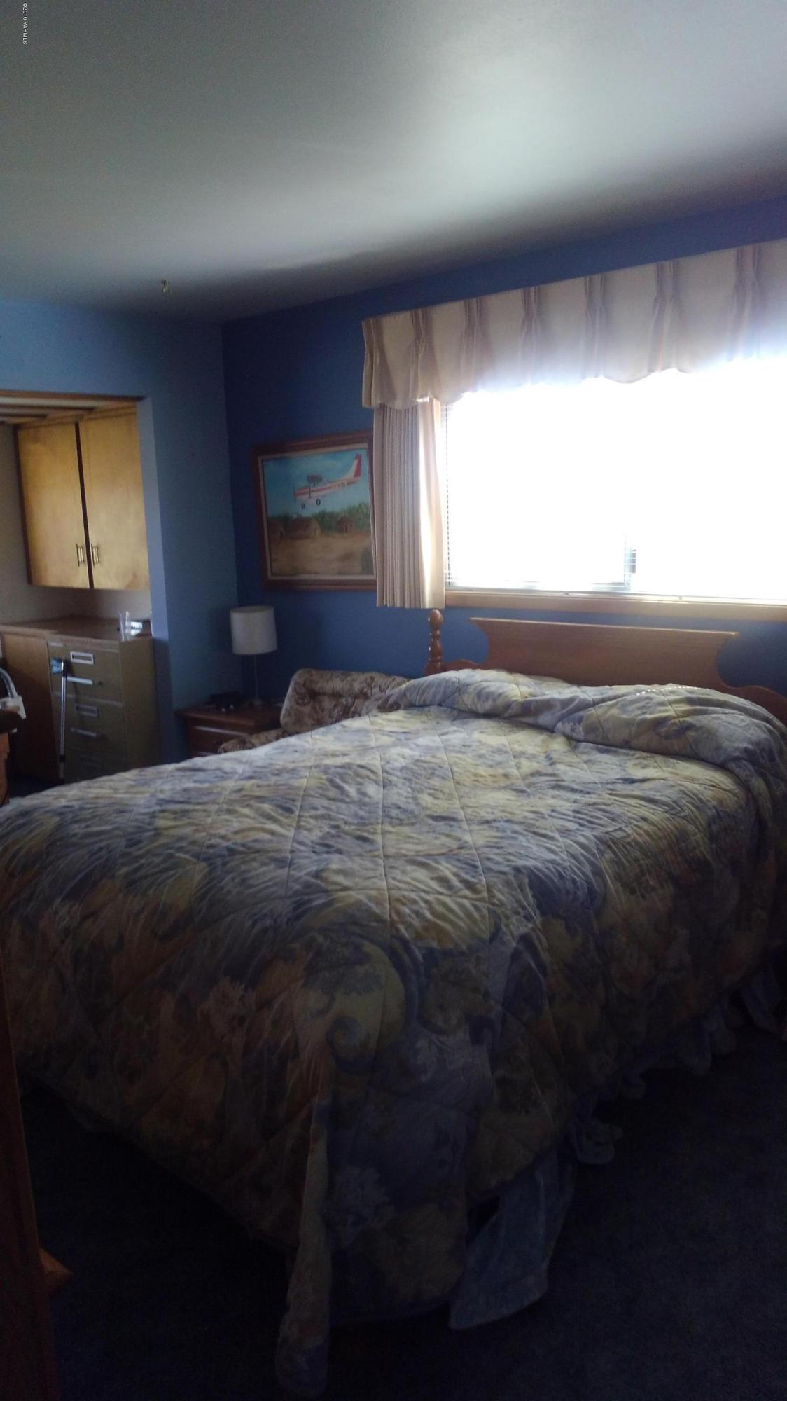 10043 Fort Road Wapato, WA 98951 - Photo 42 of 64 a bed sitting in a room next to a window