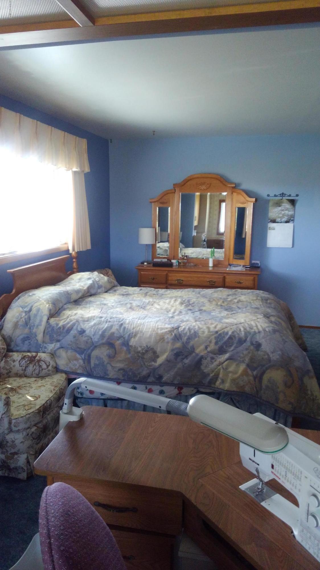 10043 Fort Road Wapato, WA 98951 - Photo 44 of 64 a bedroom with a bed and window