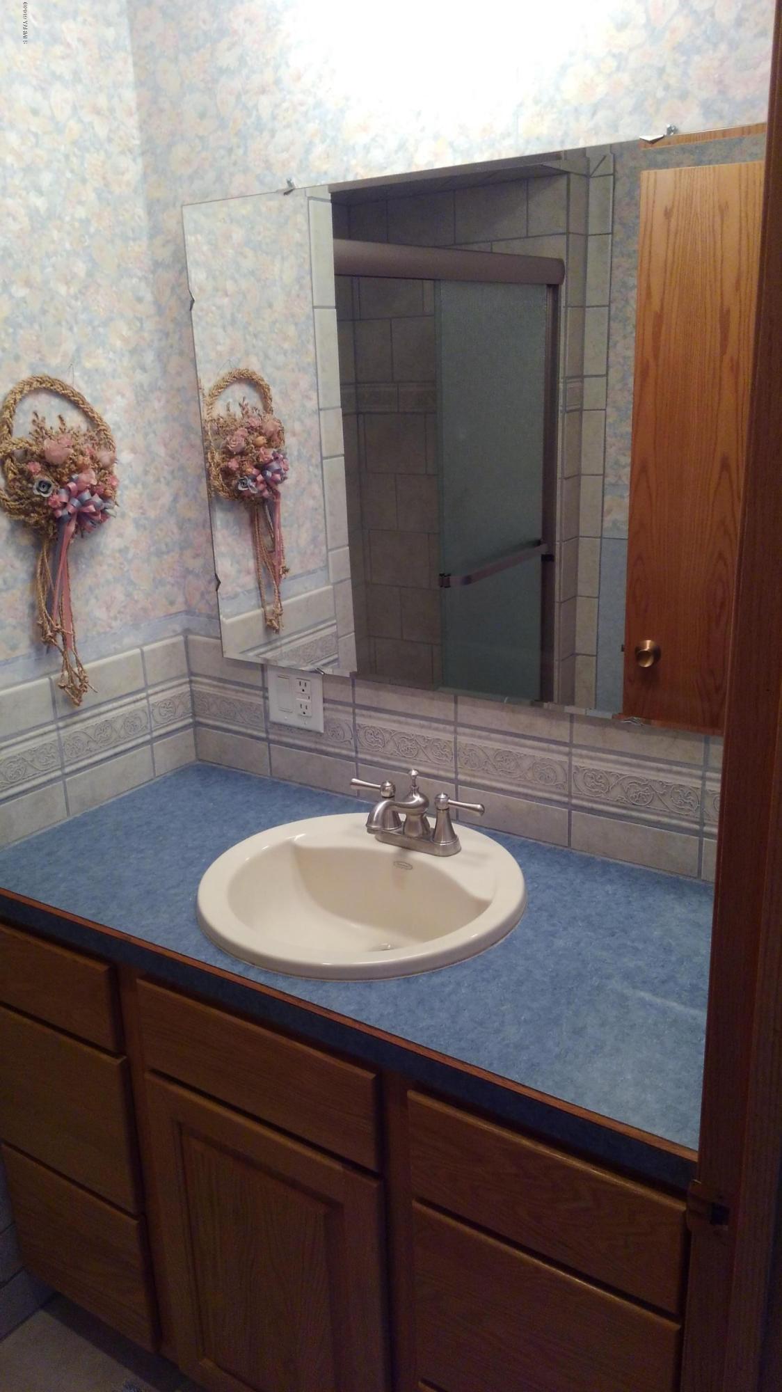 10043 Fort Road Wapato, WA 98951 - Photo 46 of 64 a bathroom with a sink and a mirror