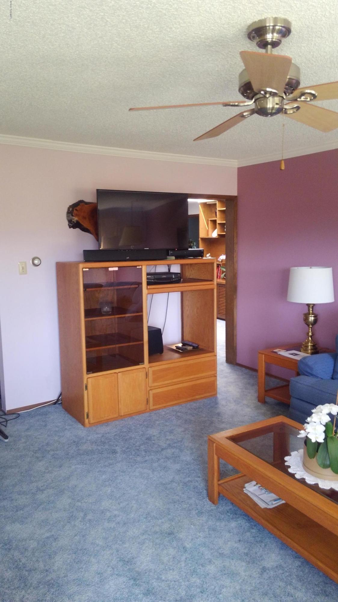10043 Fort Road Wapato, WA 98951 - Photo 53 of 64 a living room with furniture and a flat screen tv