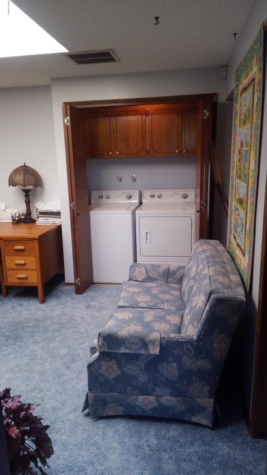 10043 Fort Road Wapato, WA 98951 - Photo 58 of 64 a bedroom with a bed and a utility room