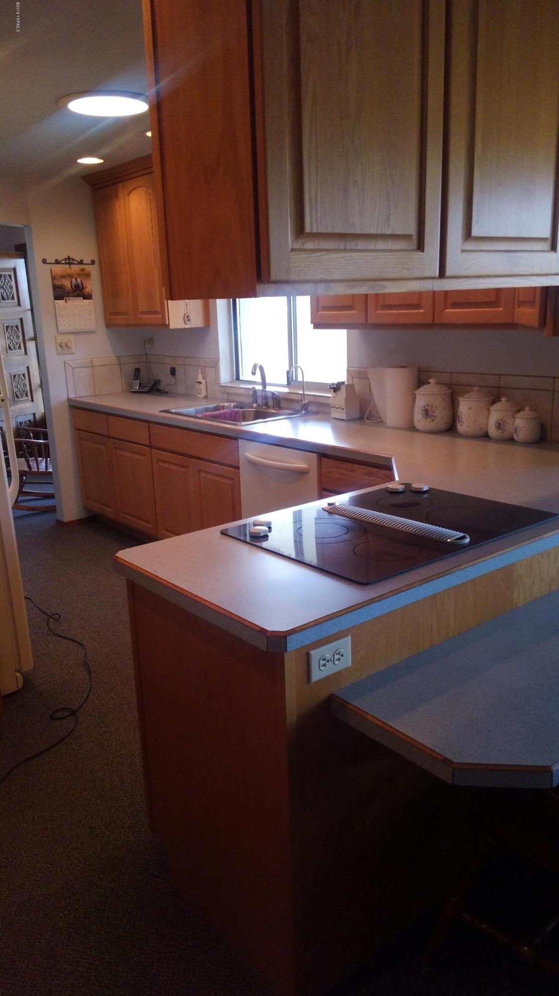 10043 Fort Road Wapato, WA 98951 - Photo 59 of 64 a kitchen with granite countertop a sink a stove and cabinets