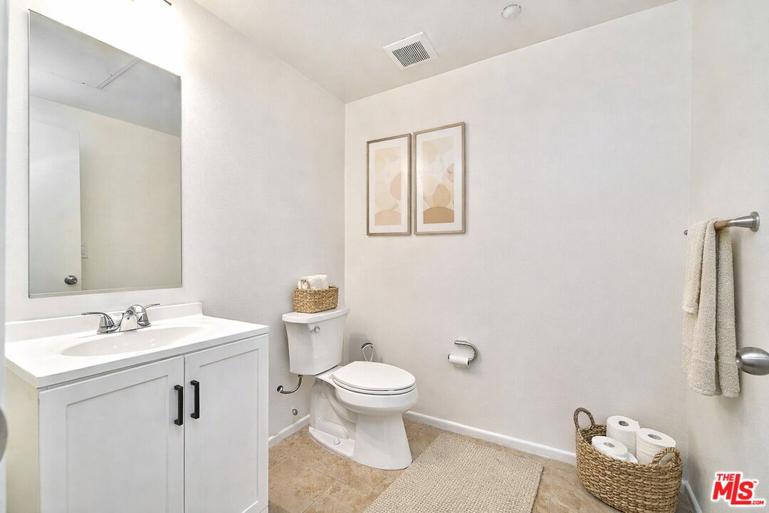 2864 Sunset Place, Unit 203 Los Angeles, CA 90005 - Photo 17 of 26 a bathroom with a sink a toilet and a mirror