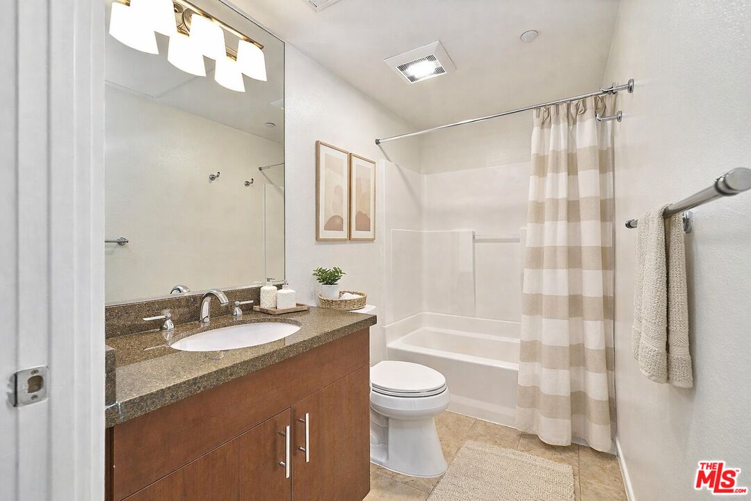 2864 Sunset Place, Unit 203 Los Angeles, CA 90005 - Photo 21 of 26 a bathroom with a sink a toilet and shower