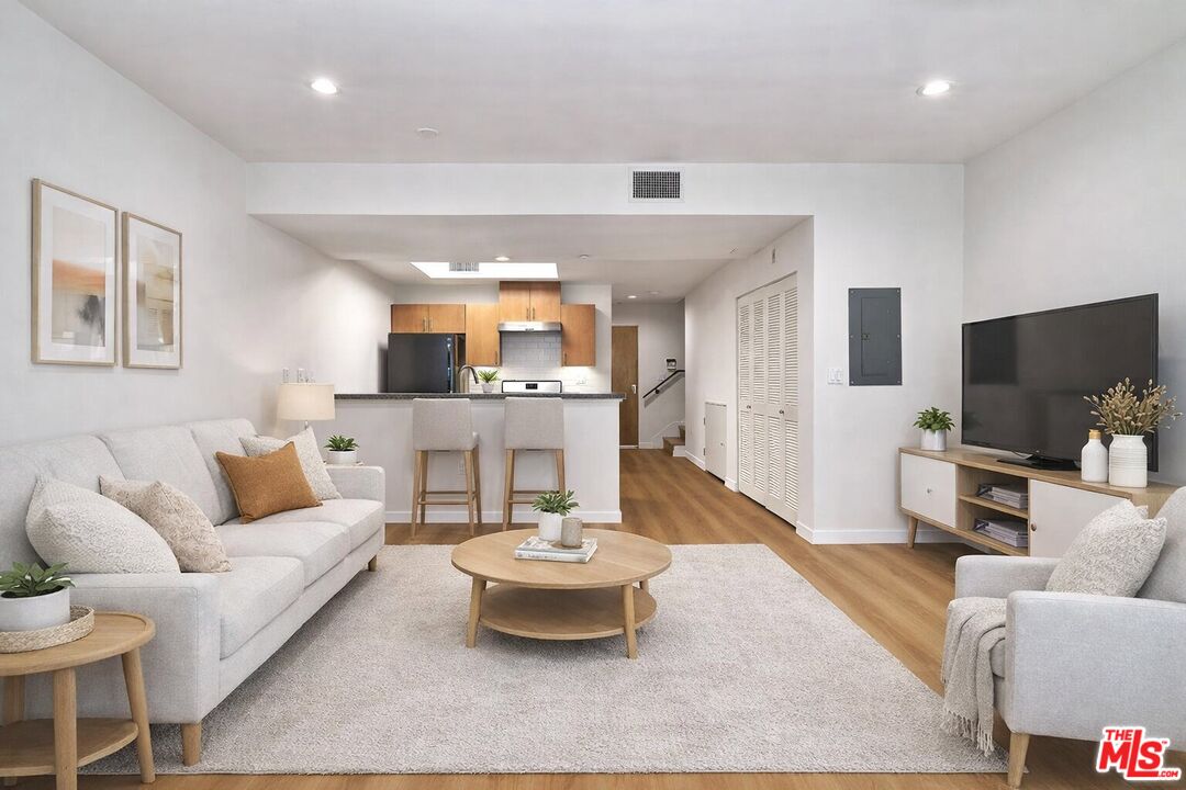 2864 Sunset Place, Unit 203 Los Angeles, CA 90005 - Photo 3 of 26 a living room with furniture and a flat screen tv