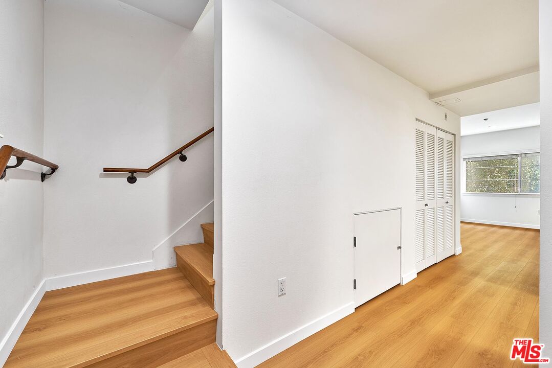 2864 Sunset Place, Unit 203 Los Angeles, CA 90005 - Photo 10 of 26 a view of a room with wooden floor and staircase