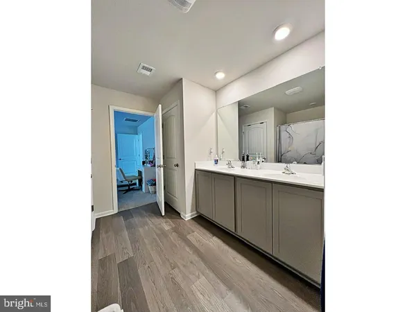 a bathroom with a sink mirror and a toilet