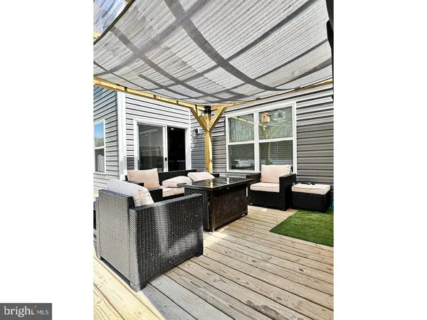 a view of a living room and kitchen with a large window