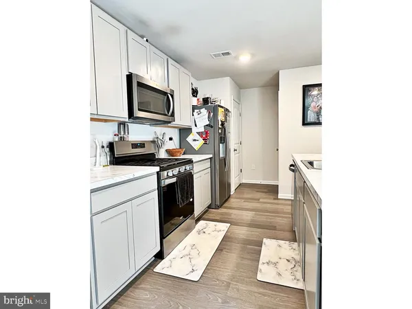 a kitchen with stainless steel appliances granite countertop a sink and a stove
