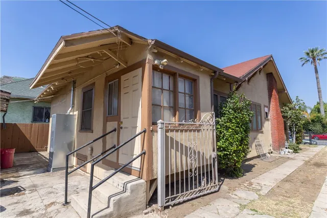 a view of a house with wooden fence