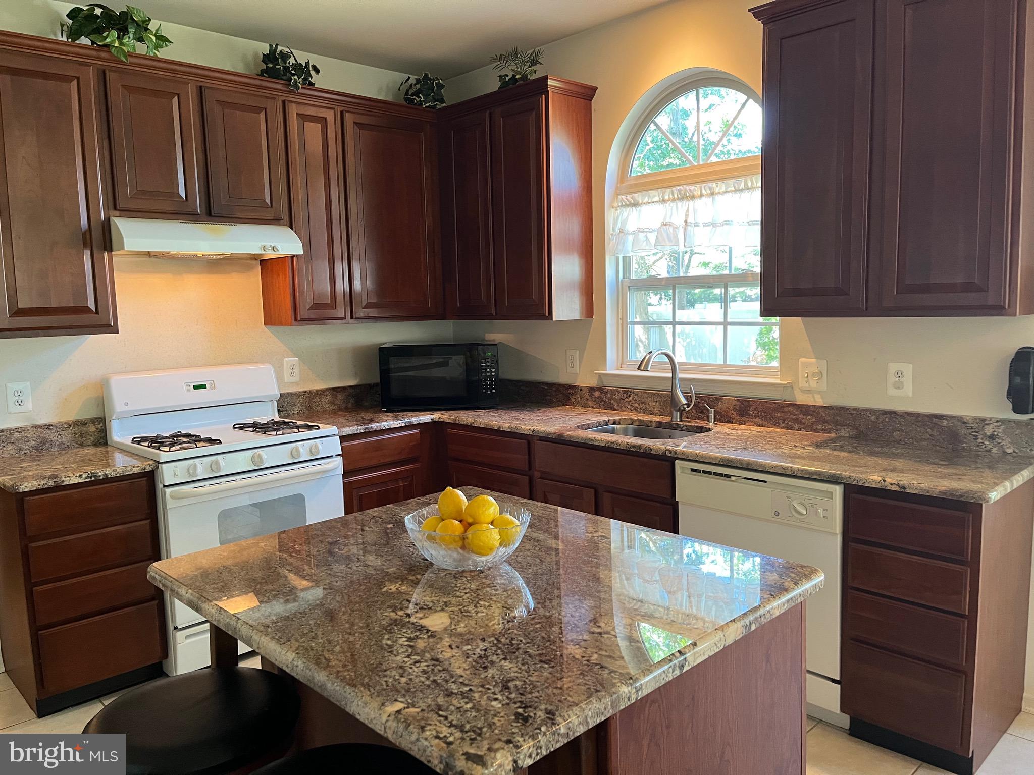 960 Butler Drive Williamstown, NJ 08094 - Photo 11 of 44 a kitchen with a refrigerator a stove a sink cabinets and a window