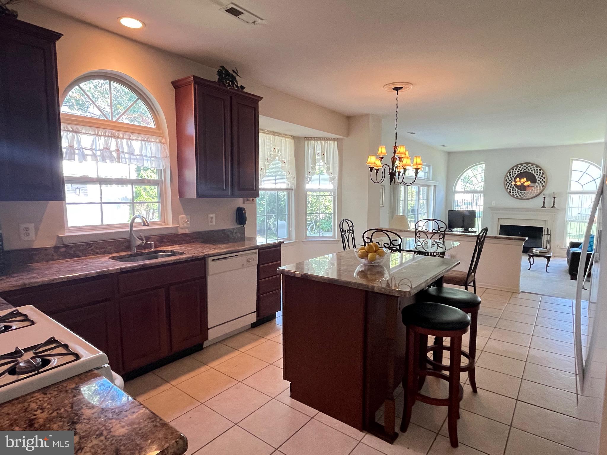 960 Butler Drive Williamstown, NJ 08094 - Photo 12 of 44 a large kitchen with granite countertop a stove a sink dishwasher and a dining table with dishwasher