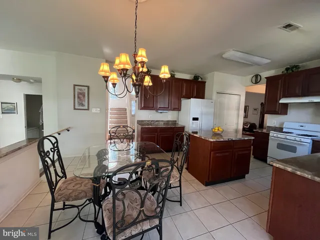 a view of a dining room with furniture and a chandelier