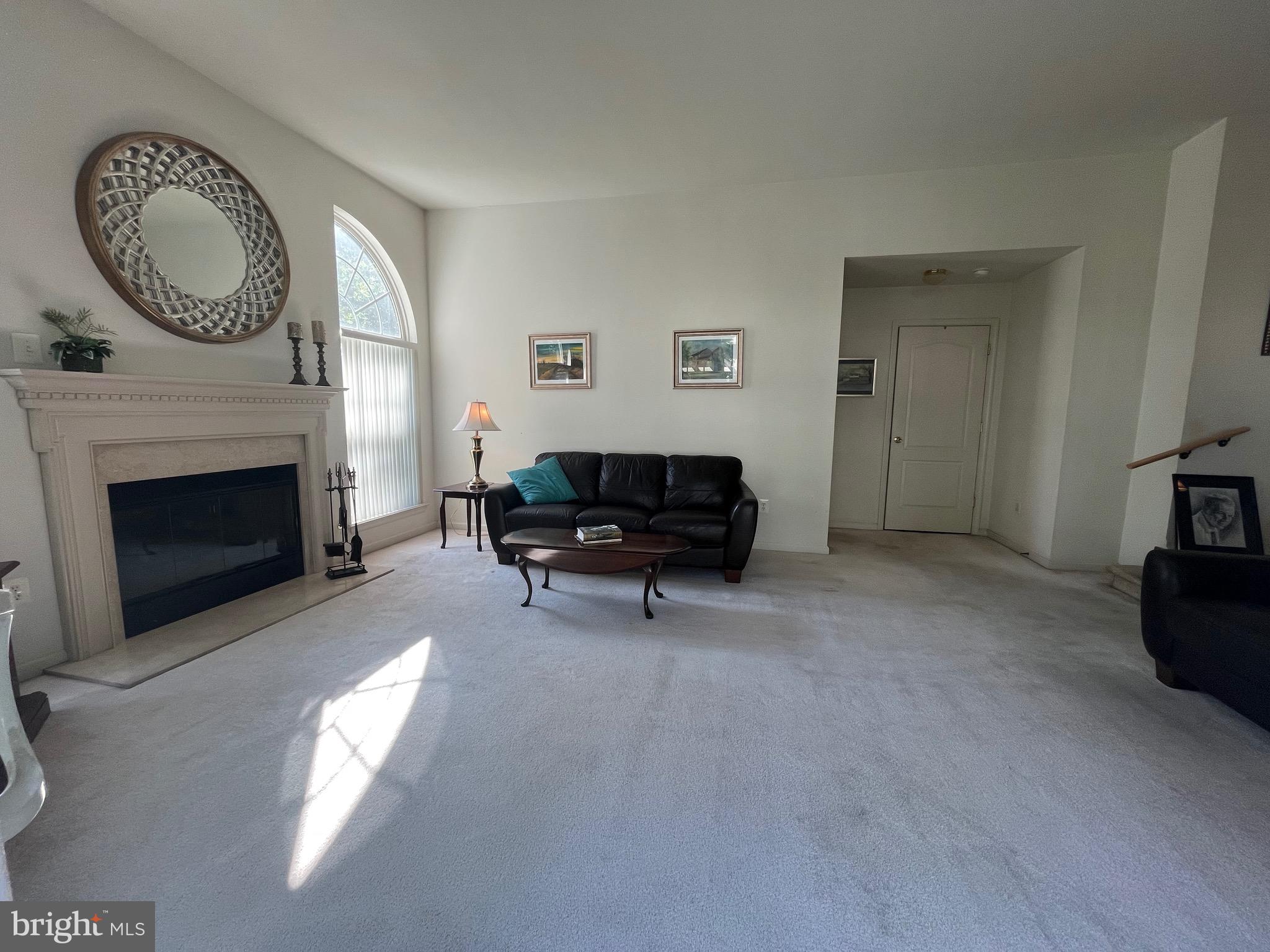 960 Butler Drive Williamstown, NJ 08094 - Photo 17 of 44 a living room with furniture a fireplace and a flat screen tv