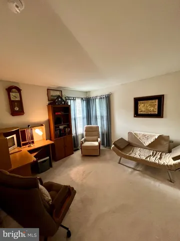 a bedroom with furniture and a lamp