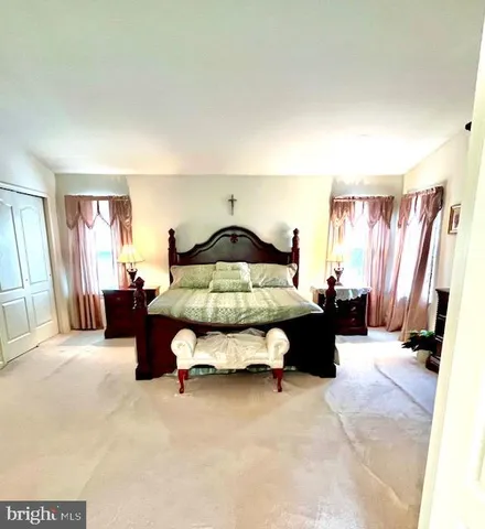 a spacious bedroom with a bed and a couch