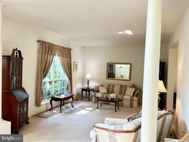 a living room with furniture a window and a flat screen tv