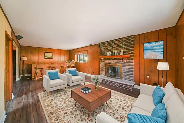 a living room with furniture and a fireplace