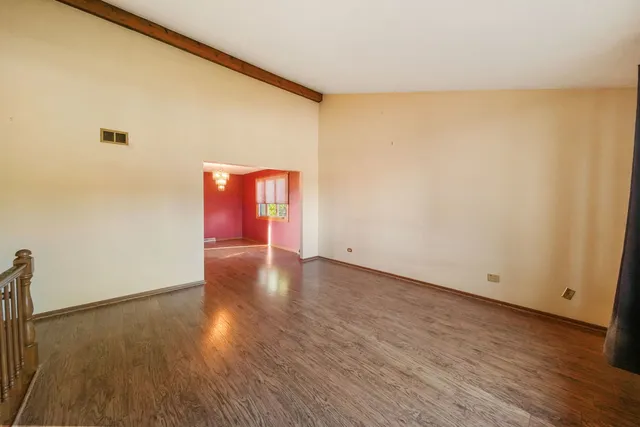 a view of an empty room and wooden floor