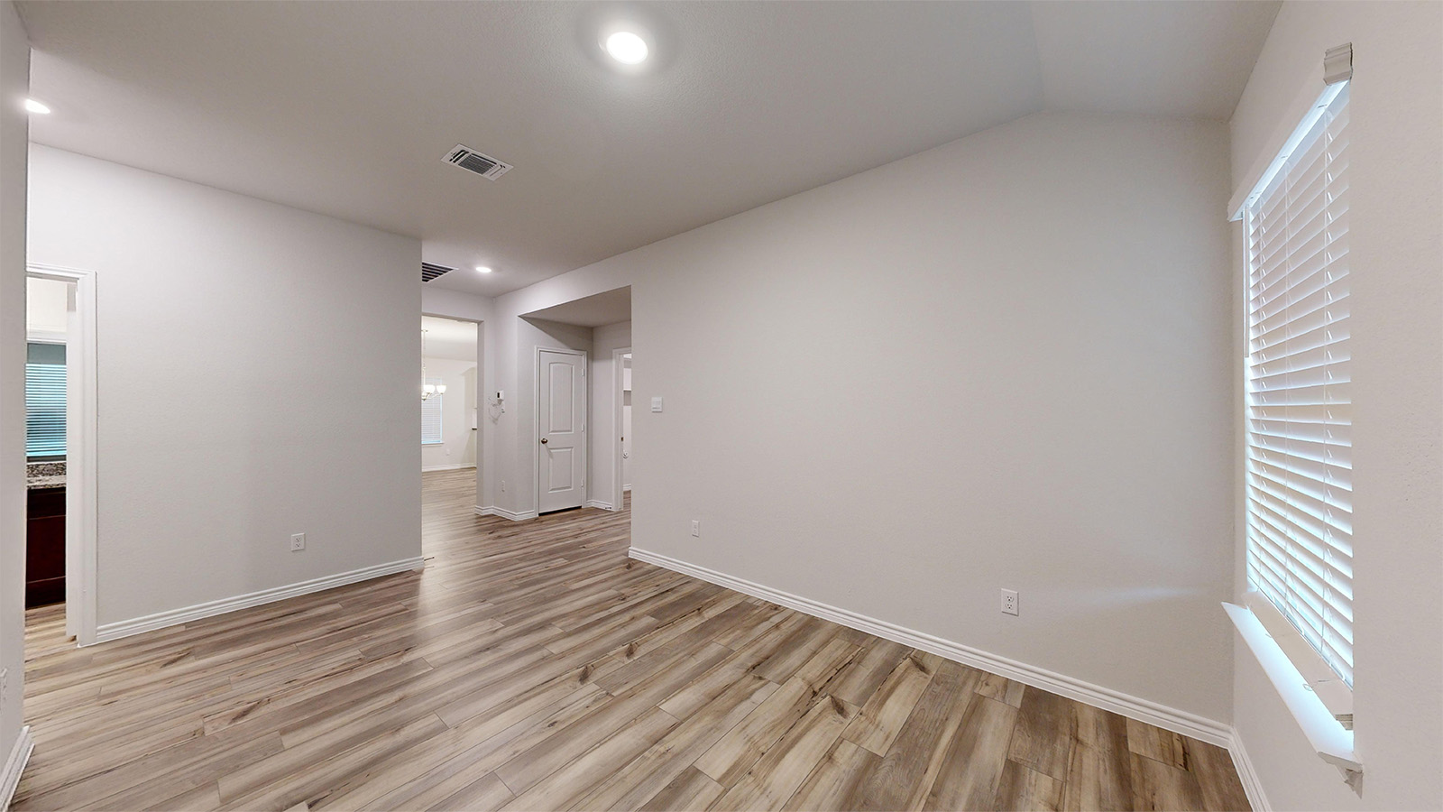 700 Gauge Road Thorndale, TX 76577 - Photo 10 of 22 Unfurnished room with light wood-style floors, healthy amount of natural light, vaulted ceiling, and recessed lighting