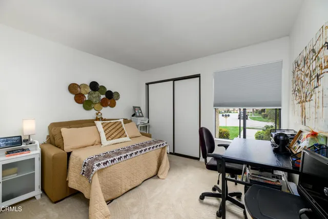 a bedroom with a bed and a desk