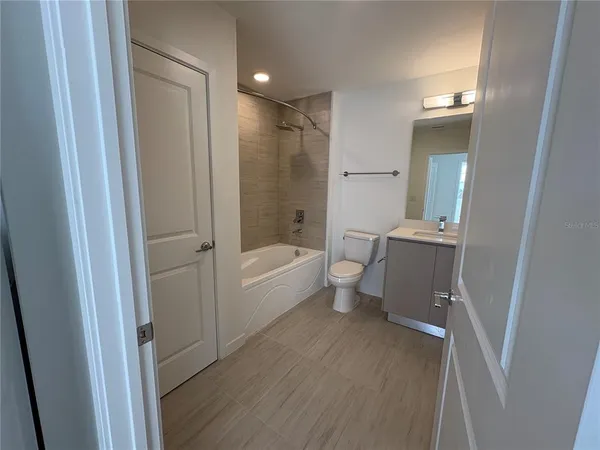 a bathroom with a bathtub toilet and a shower